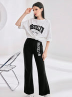 Mulvari Women Spring/Summer Casual Loose Fit Drop Shoulder Short Sleeve Top And Flared Pants Set shein