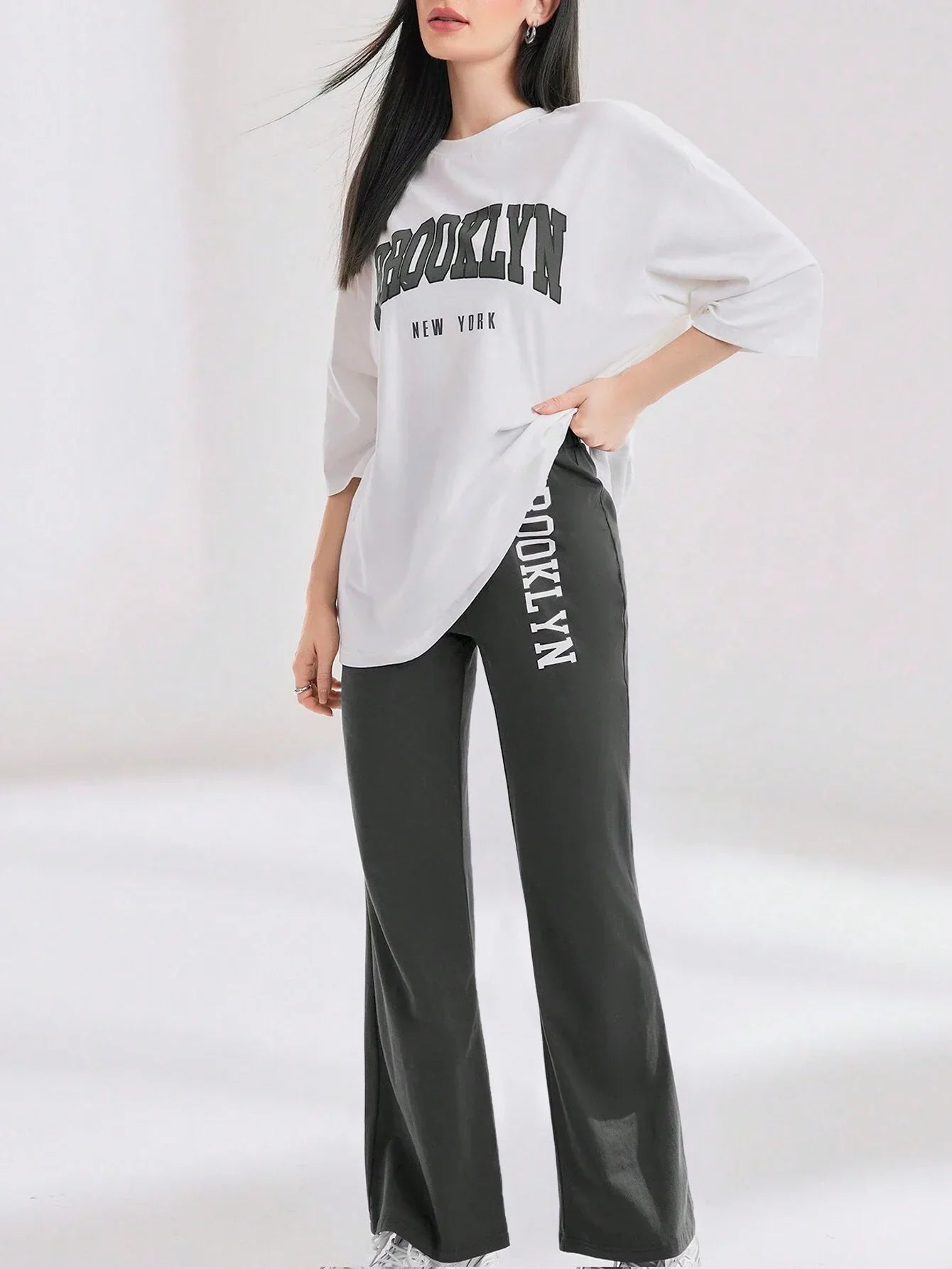 Mulvari Women Spring/Summer Casual Loose Fit Drop Shoulder Short Sleeve Top And Flared Pants Set shein