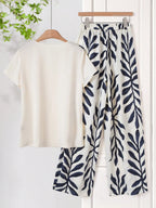 Women Solid Color Round Neck Short Sleeve Top And Flower Print Wide Leg Pants Set shein