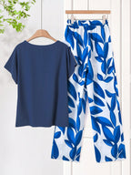 Women Solid Color Round Neck Short Sleeve Top And Flower Print Wide Leg Pants Set shein